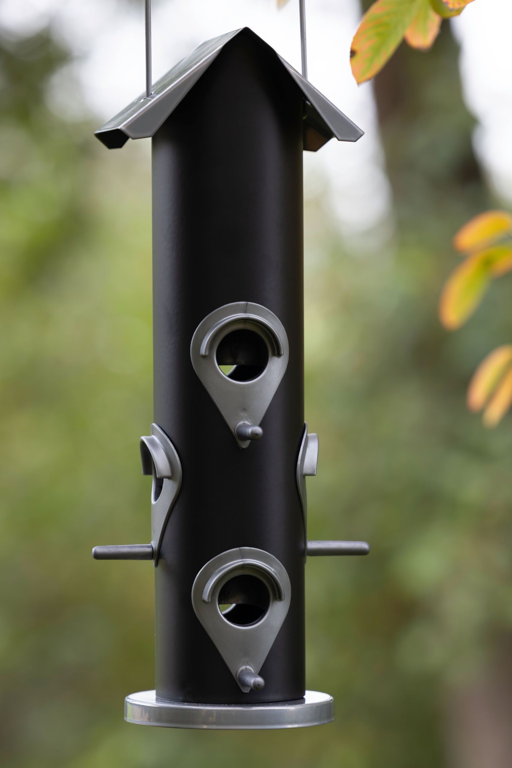 bird feeder, hanging feeder, metal pole, seed ports, outdoor decor