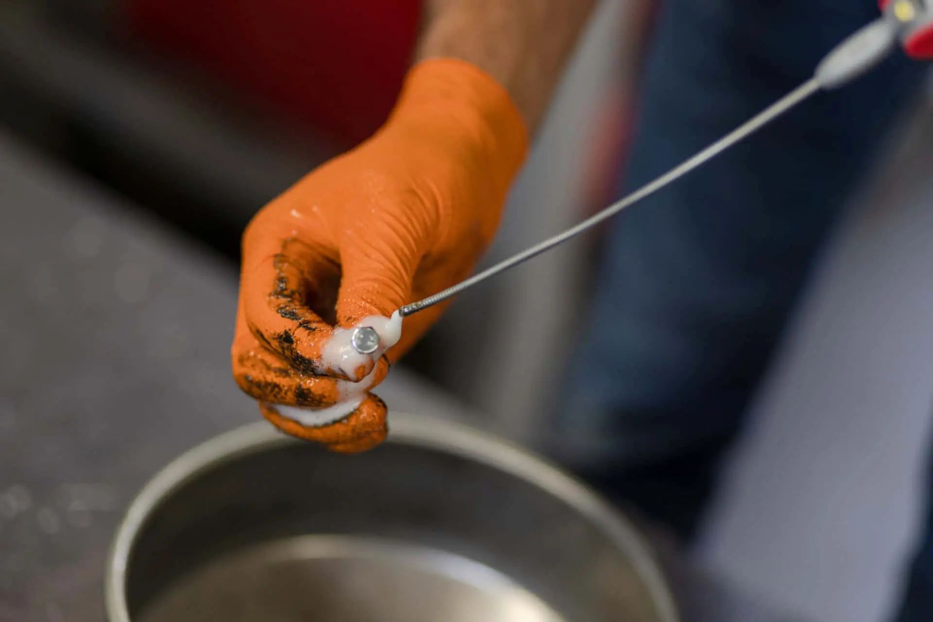 Kerbl Nitril Einmalhandschuh X-Grip, orange, rutschfest, 50 Stück, im Einsatz, in der Hand