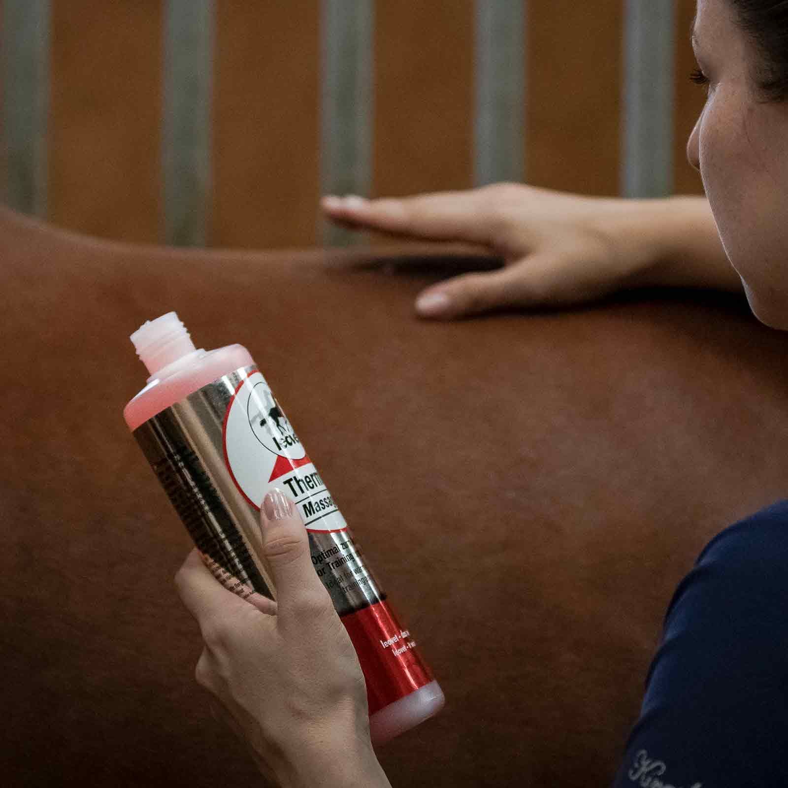 Leovet Thermo-Massage Gel for Horses, warming & circulation-boosting, 500 ml, in use, held in hand