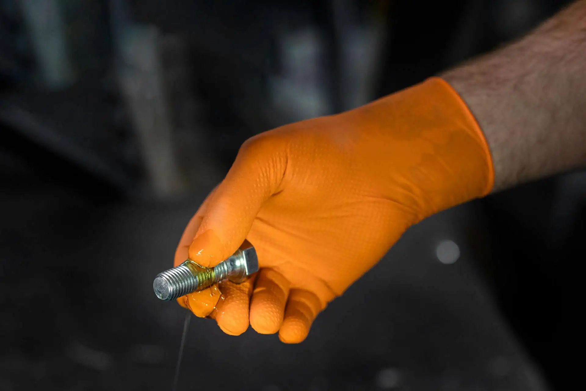 Gant jetable Nitrile X-Grip Kerbl, orange, 50 pièces, en utilisation, dans la main