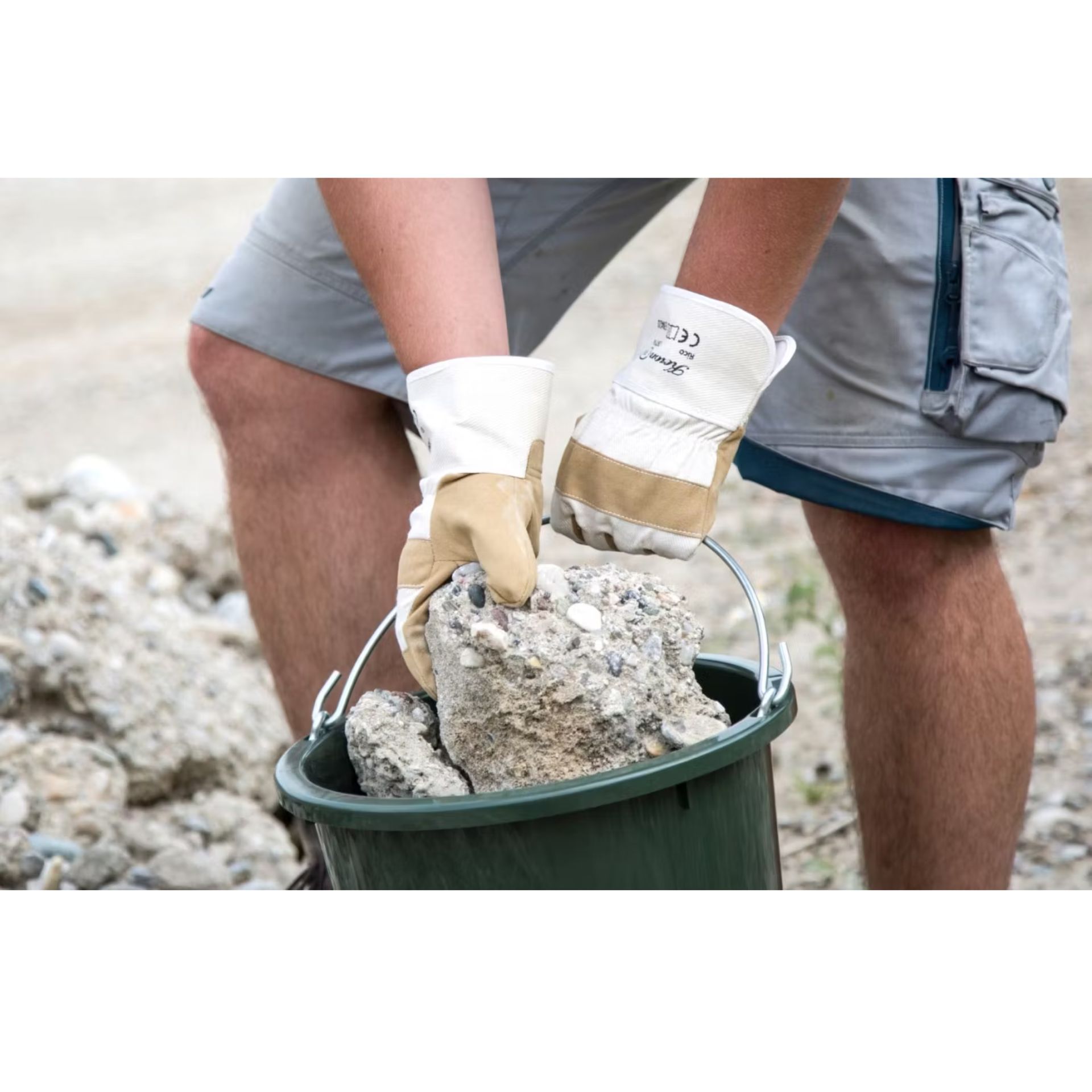 calf, cow, barn, feeding trough, yellow ear tags, gloves, work gloves, bucket, rocks, construction