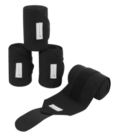 Drei gerollte schwarze Fleece Bandagen und eine ausgerollte Bandage mit Klettverschluss