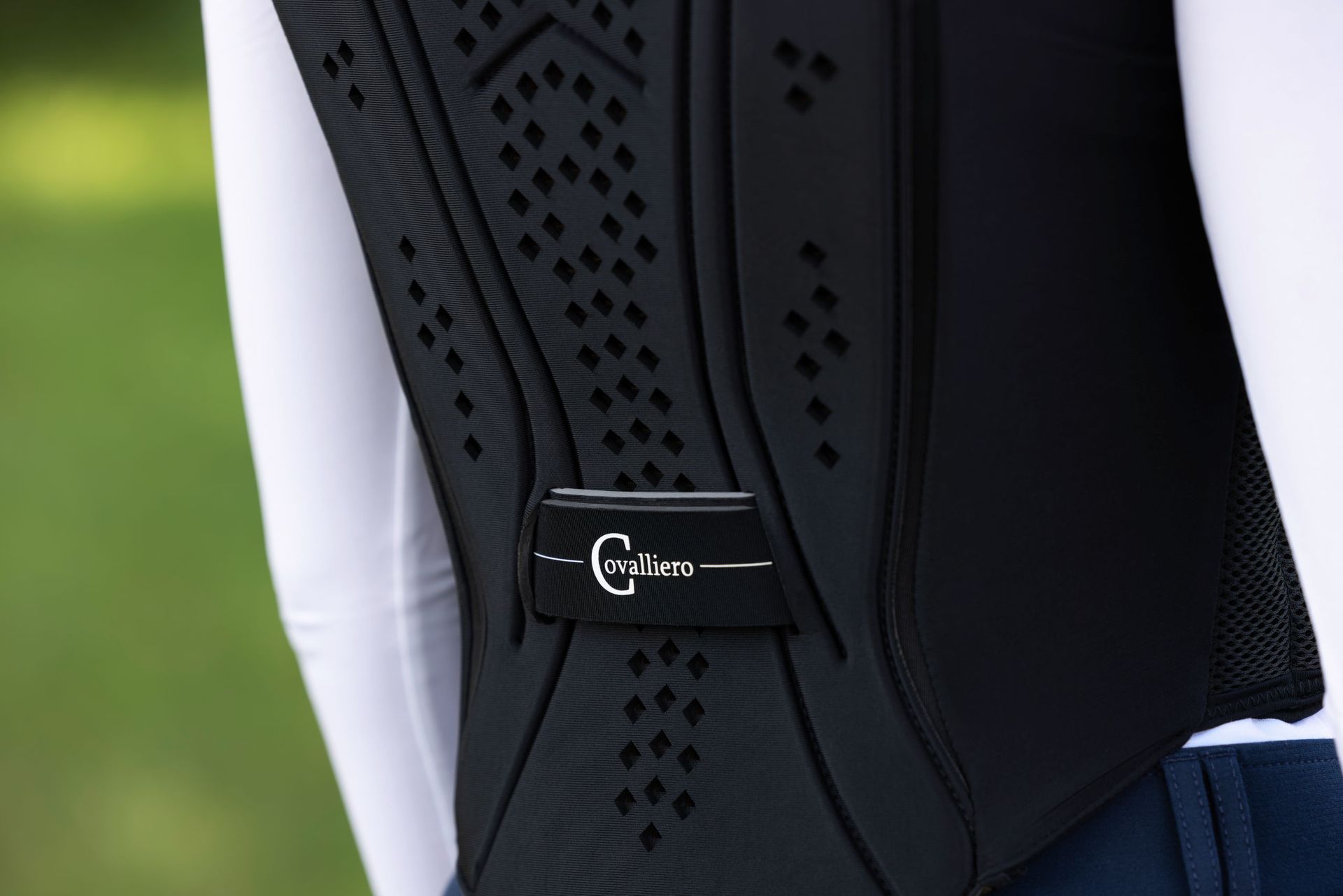 Vue de dos d'un gilet d'équitation noir à losanges avec logo Cavaliero