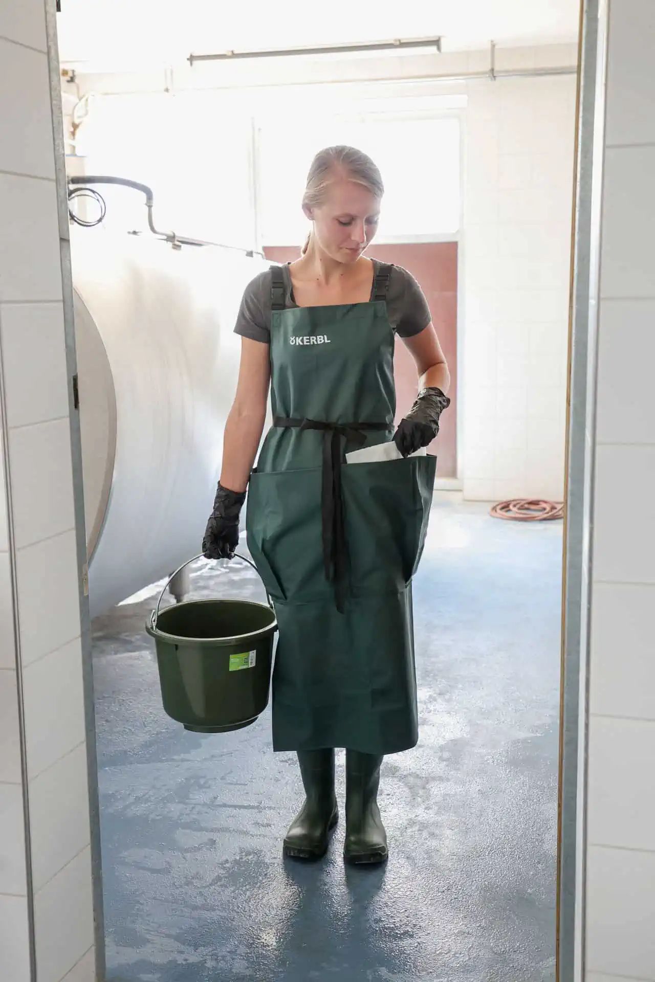 Kerbl Premium Milking Apron with Pockets, Waterproof, in use