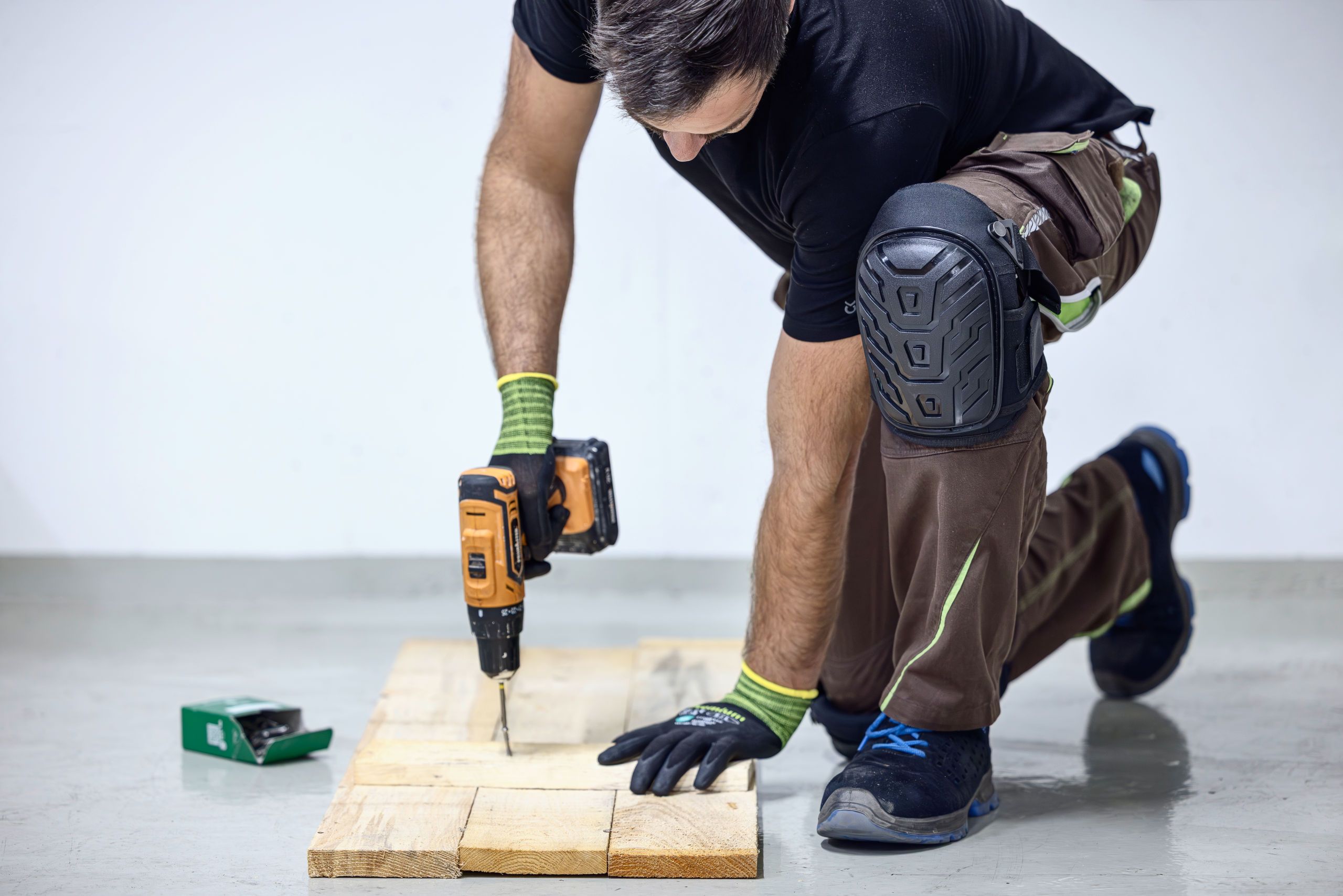 drill, screws, wood plank, work gloves, knee pad