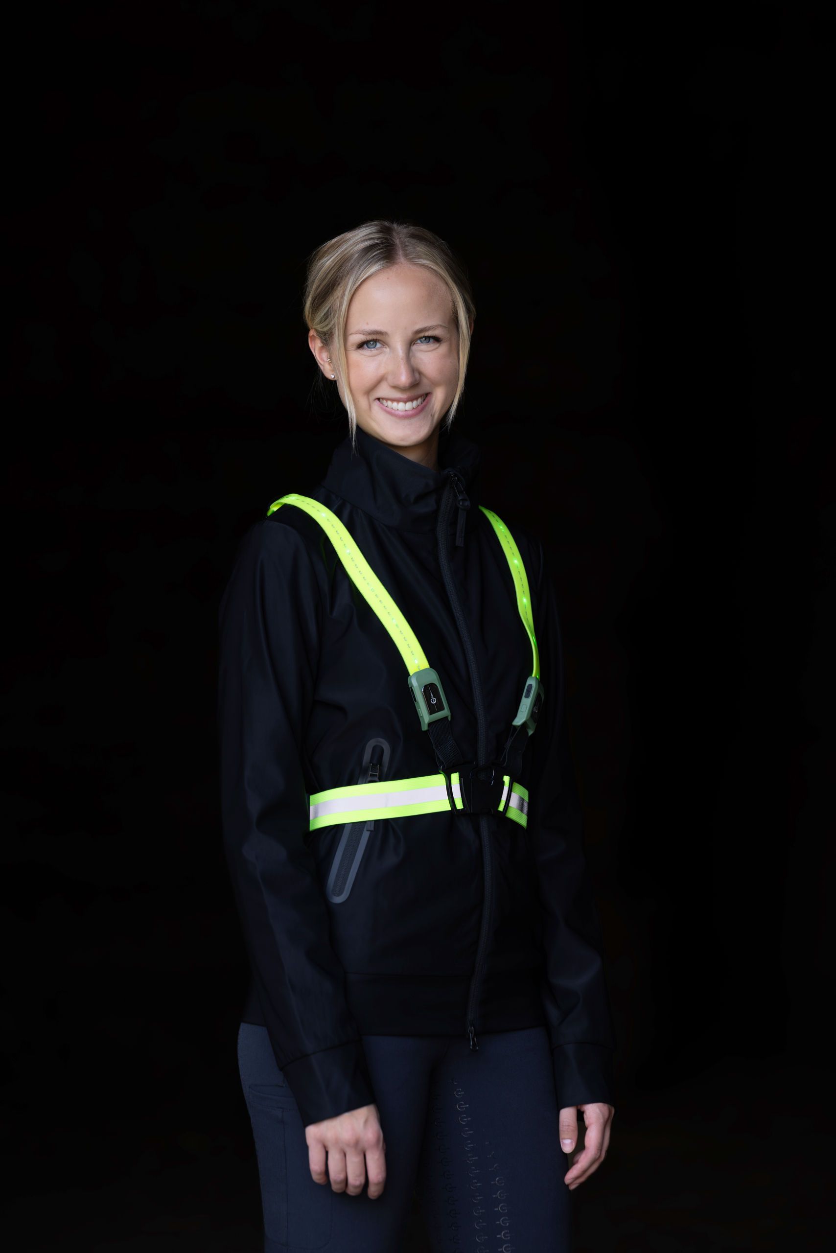 high-visibility vest, safety harness, neon straps, black jacket, reflective gear